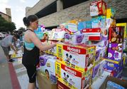 Volunteer Elizabeth Haley organizes boxes of infant diapers donated for hurricane Harvey victims at a North Dallas donation drop off location