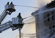 Firefighters work to contain a blaze at a building in the Bronx section of New York