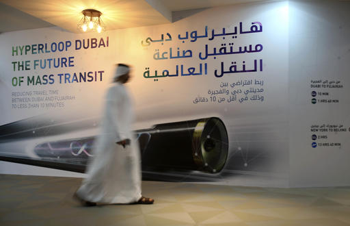 An Emirati man passes by a poster presenting Hyperloop Dubai