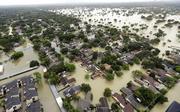 Water from Addicks Reservoir flows into neighborhoods as floodwaters from Tropical Storm Harvey rise Tuesday