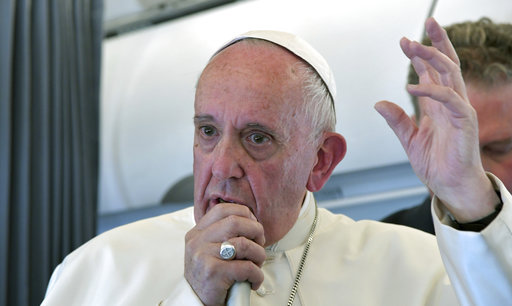 Pope Francis addresses journalists during the traditional press conference on his flight back to Rome