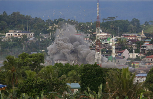 Debris fly as Philippine Air Force fighter jets bomb suspected locations of Muslim militants as fighting continues in Marawi city