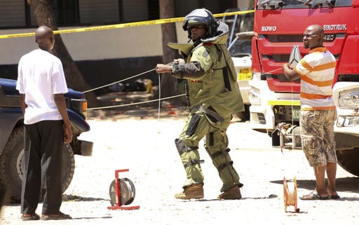 A member of a bomb disposal team prepares the scene before checking the bodies of three women who were shot dead by police