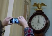 Photographers take a picture of the Ohio Clock shortly after midnight early Friday