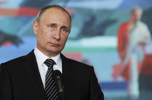 Russian President Vladimir Putin listens to a journalist's question during a news conference after a CIS (Commonwealth of Independent States