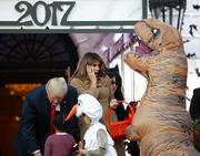 President Donald Trump and first lady Melania Trump hand out treats as they welcome children from the Washington area and children of military families to trick-or-treat celebrating Halloween at the South Lawn of the White House in Washington