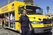 Clark County Fire Department engineer Brian Emery stands by one of his agency's Mass Casualty Incident vehicles in Las Vegas on Thursday