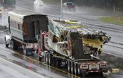 Two damaged train cars sit on flatbed trailers after being taken from the scene of an Amtrak train crash onto Interstate 5 a day earlier Tuesday
