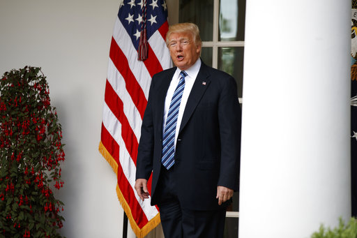 President Donald Trump talks with reporters as he walks to the Oval Office of the White House in Washington