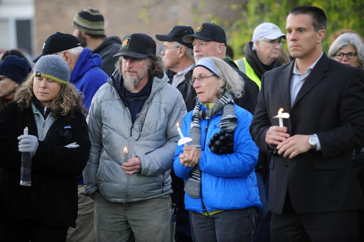 Mourners hold candles Monday