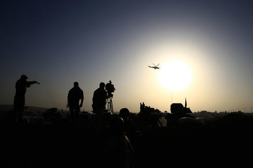 An Iraqi military helicopter flies over the frontline near Bartella