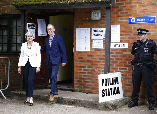 Britain's Prime Minister Theresa May leaves with her husband Philip after voting in the general election at polling station in Maidenhead