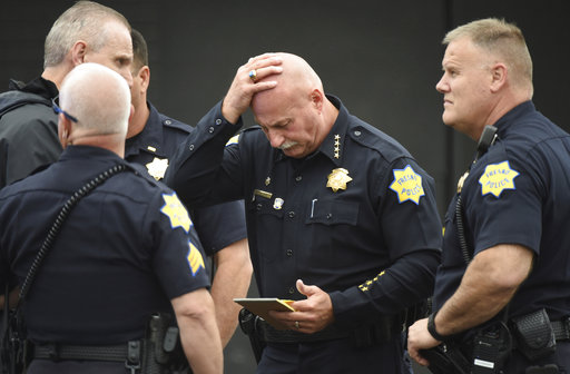 Fresno Police chief Jerry Dyer reviews notes on the triple fatal shooting before addressing the media Tuesday