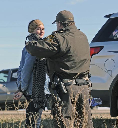 A Morton County Sheriff's deputy officer arrests actress Shailene Woodley at a protest against the Dakota Access Pipeline near St. Anthony