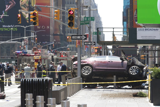 A car rests on a security barrier in New York's Times Square after driving through a crowd of pedestrians
