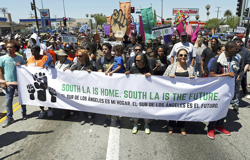 People begin a march at the corner of Florence and Normandie
