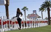 Sherri Camperchioli helps set up some of the crosses that arrived in Las Vegas today to honor the victims of the mass shooting on Thursday