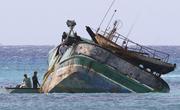 Workers prepare the 79-foot Pacific Paradise commercial fishing vessel for salvage off the shore of Honolulu