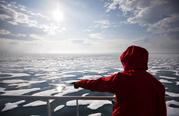 Researcher Tiina Jaaskelainen points out a possible sighting of wildlife aboard the Finnish icebreaker MSV Nordica as it traverses the Northwest Passage through the Canadian Arctic Archipelago