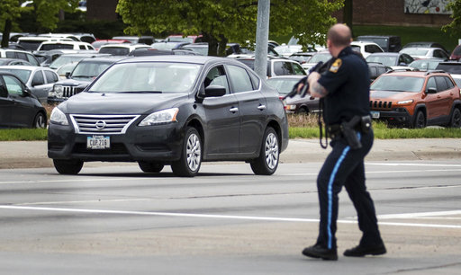An Omaha police officer points his rifle in the direction of a vehicle headed eastbound on Cuming Street driven by an inmate who escaped from the Pottawattamie County jail in Council Bluffs