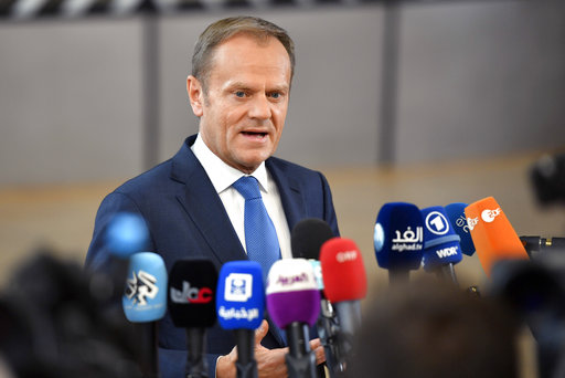 European Council President Donald Tusk speaks with the media as he arrives for an EU summit at the Europa building in Brussels on Saturday