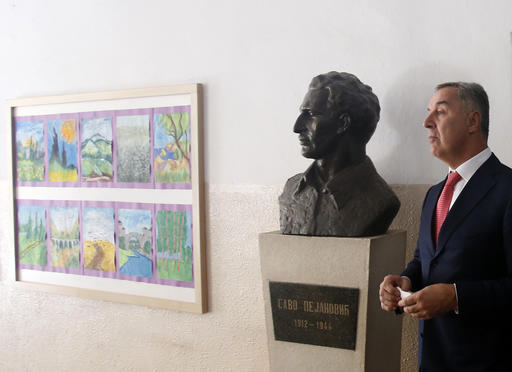 Montenegro's Prime Minister Milo Djukanovic leaves polling station after voting in parliamentary elections in Podgorica