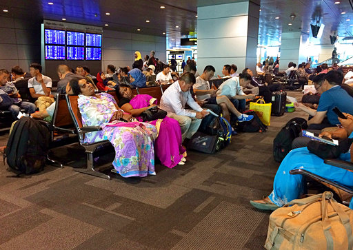 Passengers of cancelled flights wait in Hamad International Airport (HIA) in Doha