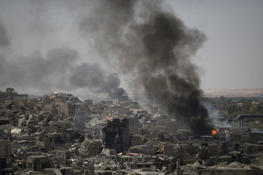 Smoke billows after airstrikes hit Islamic State positions on the edge of the Old City a day after Iraq's prime minister declared "total victory" in Mosul
