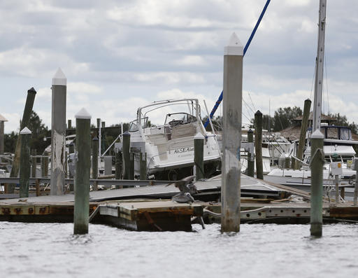 A boat rests on top of docks at a marina damaged by Hurricane Matthew in St. Augustine