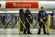 Police stand guard inside the Port Authority Bus Terminal following an explosion near Times Square on Monday