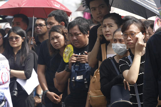 Mourners line up as they gather to pay their respects to the late Thai King Bhumibol Adulyadej at the Grand Palace in Bangkok