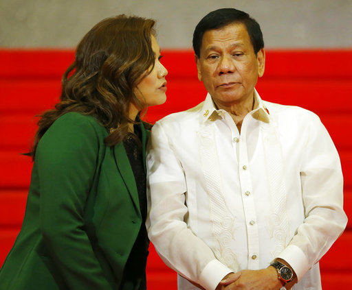 Philippine President Rodrigo Duterte and partner Honeylet Avancena chat as they wait for the arrival of Southeast asian leaders for the opening ceremony of the 30th ASEAN Leaders' Summit Saturday