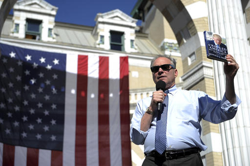 Democratic vice presidential candidate Tim Kaine uses a Donald Trump book as a talking point during a rally on the campus of Carnegie Mellon University