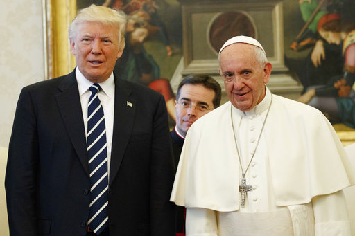 U.S. President Donald Trump stands with Pope Francis during a meeting