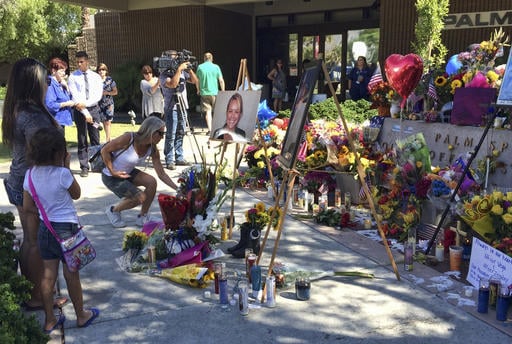 People leave flowers at a memorial for Palm Springs Police Officers Lesley Zerebny