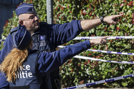 Police investigate the scene where a man stabbed two police officers