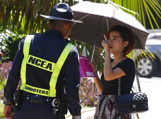 A woman asks for directions as Resorts World Manila complex remains on a lockdown Saturday