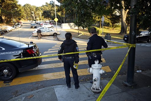 San Francisco Police stand at the site of a shooting outside the June Jordan School for Equity and City Arts and Technology High School