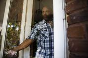 Earl Rice Jr. steps out of his home in Wilmington