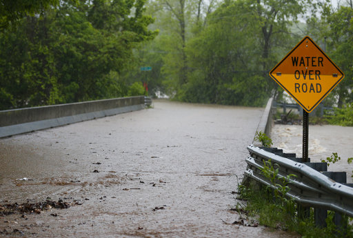 Water begins to cover the Kinser Bridge on Farm Road 164 on Saturday