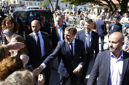France's President Emmanuel Macron meets people as he arrives at his house in Le Touquet