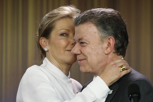 Colombia's President Juan Manuel Santos is embraced by his wife Maria Clemencia Rodriguez after speaking to journalists at the presidential palace in Bogota