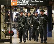 Police officers patrol in the passageway connecting New York City's Port Authority bus terminal and the Times Square subway station on Tuesday
