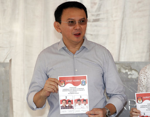 Jakarta Governor Basuki "Ahok" Tjahaja Purnama who is seeking for his second term in office shows his ballot during the runoff election in Jakarta