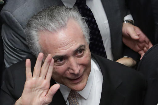 Brazil's President Michel Temer waves as he arrives to take the presidential oath at the National Congress