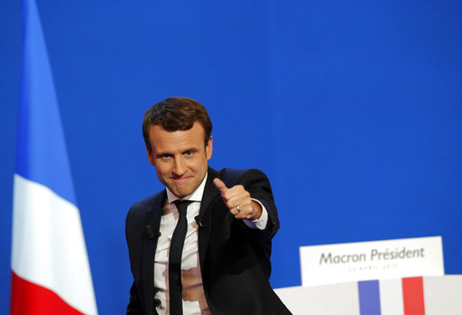 French centrist presidential candidate Emmanuel Macron thumbs up as he addresses his supporters at his election day headquarters in Paris