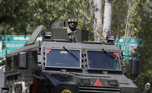 An Indian army soldier guards the army base which was attacked by suspected rebels in the town of Uri