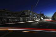 Lights from automobile traffic leave trails on a street in Freeport