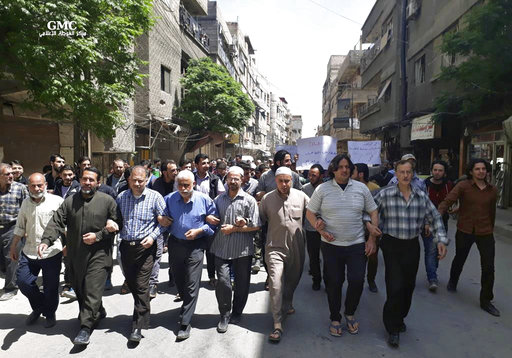 This photo provided by the Syrian anti-government activist group Ghouta Media Center