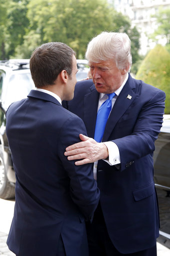 French President Emmanuel Macron welcomes U.S President Donald Trump at Les Invalides museum in Paris Thursday